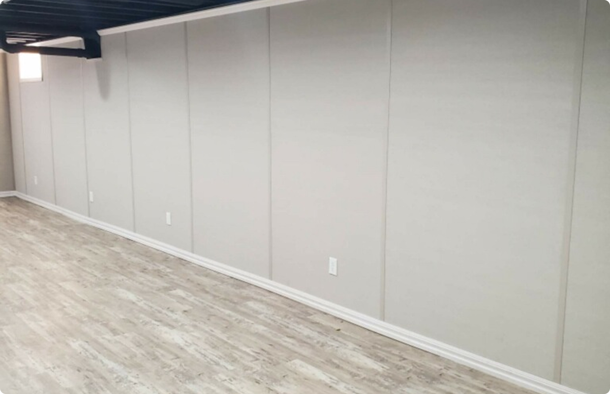 Empty room with gray walls and wood flooring.