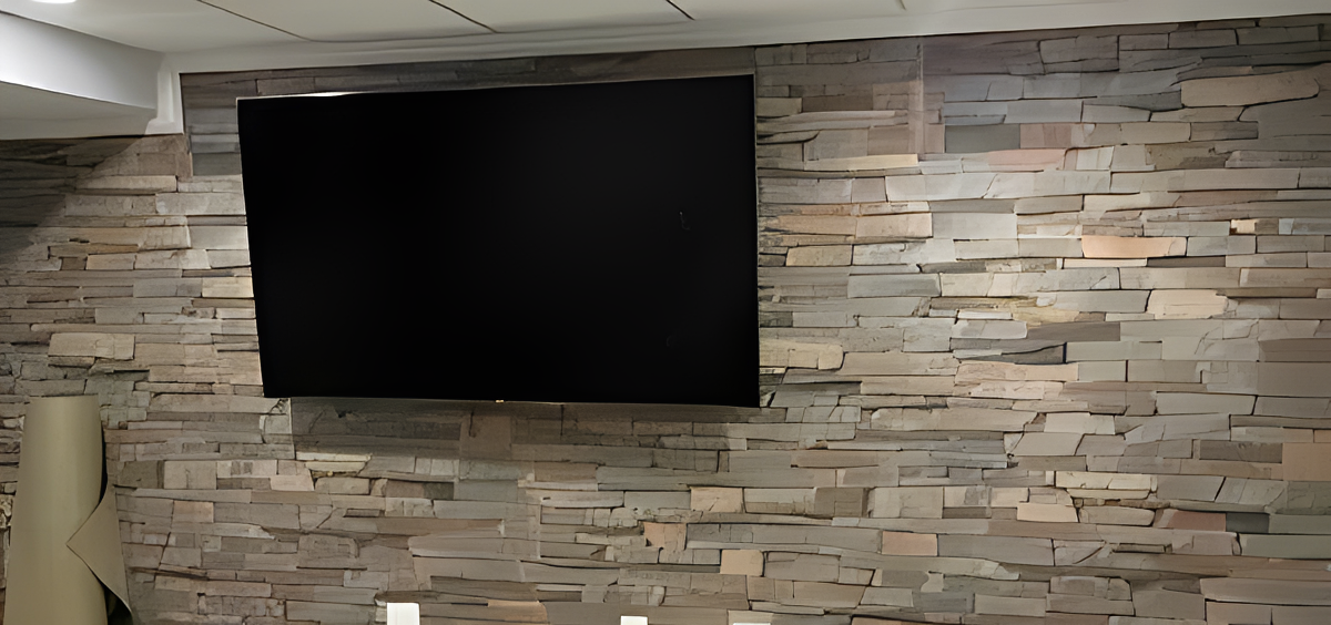 Flat screen TV on stone wall